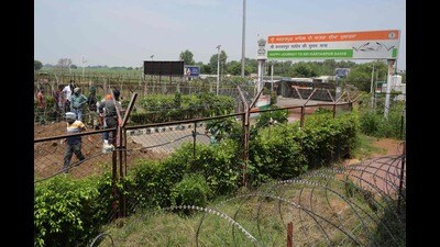 Villagers look at the zero line fencing near India-Pakistan border submerged in floodwaters at Kartarpur Corridor near Dera Baba Nanak, about 54 km from Amritsar on July 20. (AFP)