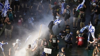 Israeli police use a water cannon to disperse demonstrators blocking a road during a protest against plans by Prime Minister Benjamin Netanyahu's government to overhaul the judicial system, in Jerusalem, Monday. (AP)