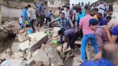 A two-storeyed building collapsed in Junagadh. (ANI)