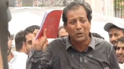 Congress leader Rajendra Gudha with the 'red diary'. (ANI) Congress leader Rajendra Gudha with the 'red diary'. (ANI)
