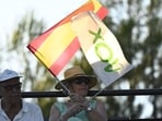 A supporter waves Vox's and Spain's flags as Spanish far-right party Vox' leader Santiago Abascal speaks during a campaign meeting in Guadalajara on July 15, 2023 ahead of July 23 general election. (Photo by OSCAR DEL POZO / AFP)