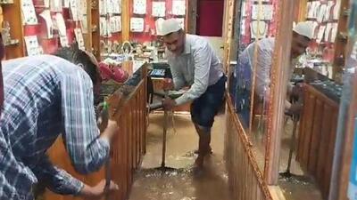 A shop owner draining out water from his store at Srinagar’s newly-revamped Poloview market. (HT Photo) A shop owner draining out water from his store at Srinagar’s newly-revamped Poloview market. (HT Photo)
