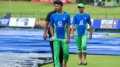 Pakistan's Naseem Shah (R) and Abrar Ahmed (L) inspect the ground after rain stops the play (AFP) Pakistan's Naseem Shah (R) and Abrar Ahmed (L) inspect the ground after rain stops the play (AFP)