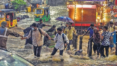 Metro commuters wade through water-logged streets after heavy rain, at Malakpet in Hyderabad on Tuesday. (ANI) Metro commuters wade through water-logged streets after heavy rain, at Malakpet in Hyderabad on Tuesday. (ANI)