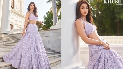 The second set of photos shows Pooja in a lavender-coloured plunge-neck choli and lehenga embellished with sequin work, detailed applique designs, and intricate bead designs. She accessorised the summer wedding look with gold bracelets and a choker necklace. Centre-parted open locks, white winged eyeliner, darkened brows, glossy caramel lip shade, rouged cheeks, mascara on the lashes, beaming highlighter, and light contouring gave the finishing touch. (Instagram/@poojahegde) The second set of photos shows Pooja in a lavender-coloured plunge-neck choli and lehenga embellished with sequin work, detailed applique designs, and intricate bead designs. She accessorised the summer wedding look with gold bracelets and a choker necklace. Centre-parted open locks, white winged eyeliner, darkened brows, glossy caramel lip shade, rouged cheeks, mascara on the lashes, beaming highlighter, and light contouring gave the finishing touch. (Instagram/@poojahegde)