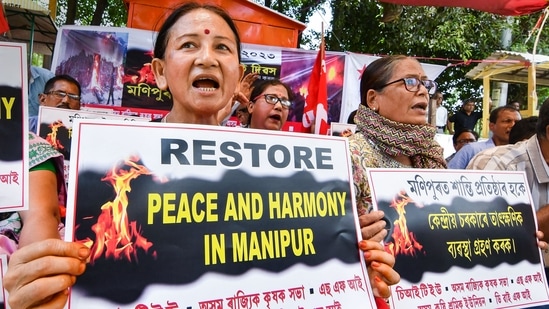 Protestors from different parties shout slogans during a protest over sexual assault against women and the ongoing ethnic violence in Manipur, in Guwahati, Tuesday. (PTI)