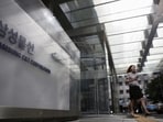  An employee walks past a logo of Samsung C&T Corp at the company's headquarters in Seoul, South Korea.