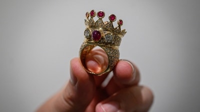 (FILES) A gold, ruby, and diamond crown ring, designed and worn by the late US rapper Tupac Shakur during his last public appearance in 1996, is displayed during a press preview at Sotheby's in New York City on July 20, 2023. A gold, ruby and diamond crown ring worn by rap legend Tupac Shakur during his last public appearance sold for $1 million at auction in New York on July 25, 2023. The winning bid was well above Sotheby's pre-sale estimate of between $200,000 and $300,000 and becomes the most valuable hip-hop artifact ever sold, the auction house said. (Photo by Ed JONES / AFP) (AFP) (FILES) A gold, ruby, and diamond crown ring, designed and worn by the late US rapper Tupac Shakur during his last public appearance in 1996, is displayed during a press preview at Sotheby's in New York City on July 20, 2023. A gold, ruby and diamond crown ring worn by rap legend Tupac Shakur during his last public appearance sold for $1 million at auction in New York on July 25, 2023. The winning bid was well above Sotheby's pre-sale estimate of between $200,000 and $300,000 and becomes the most valuable hip-hop artifact ever sold, the auction house said. (Photo by Ed JONES / AFP) (AFP)