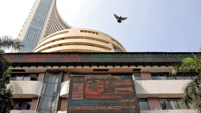 A bird flies past a screen displaying the Sensex results on the facade of the Bombay Stock Exchange (BSE) building in Mumbai. (REUTERS)