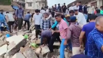 Local residents trying to rescue people trapped under the debris after a two-storey building collapsed in Junagadh Local residents trying to rescue people trapped under the debris after a two-storey building collapsed in Junagadh