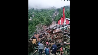 People gather near a building destroyed by flash floods and heavy rain in Kandhar village of Rampur in Shimla on Wednesday. (ANI) People gather near a building destroyed by flash floods and heavy rain in Kandhar village of Rampur in Shimla on Wednesday. (ANI)