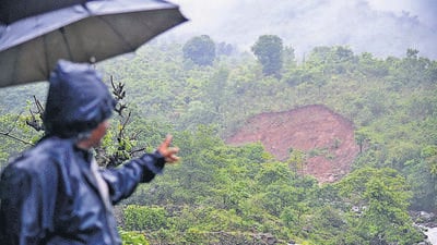 Ramchandra Dhanavale of Dhanavali shows portion of landslide at a hill, on Tuesday. (KALPESH NUKTE/HT ) Ramchandra Dhanavale of Dhanavali shows portion of landslide at a hill, on Tuesday. (KALPESH NUKTE/HT )