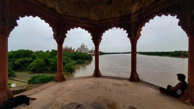 The Taj Mahal is seen on the banks of the swollen Yamuna river after heavy monsoon rainfall, in Agra,on Wednesday. (PTI)