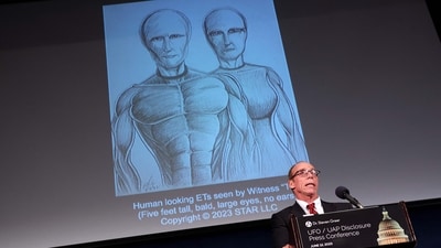 WASHINGTON, DC - JUNE 12: Steven Greer, ufologist and founded of the Center for the Study of Extraterrestrial Intelligence and the Disclosure Project, delivers remarks on his UFO and Unidentified Aerial Phenomena (UAP) research under an artist rendering of extraterrestrials, during a press conference on June 12, 2023 in Washington, DC. Greer spoke on his archive of research on UFOs consisting of government documents, whistleblower testimony and alleged locations of UFO projects sites. (Getty Images via AFP) WASHINGTON, DC - JUNE 12: Steven Greer, ufologist and founded of the Center for the Study of Extraterrestrial Intelligence and the Disclosure Project, delivers remarks on his UFO and Unidentified Aerial Phenomena (UAP) research under an artist rendering of extraterrestrials, during a press conference on June 12, 2023 in Washington, DC. Greer spoke on his archive of research on UFOs consisting of government documents, whistleblower testimony and alleged locations of UFO projects sites. (Getty Images via AFP)