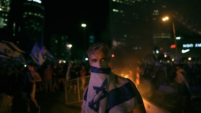 Demonstrators protest against plans by Prime Minister Benjamin Netanyahu's government to overhaul the judicial system, in Tel Aviv, Monday. (AP) Demonstrators protest against plans by Prime Minister Benjamin Netanyahu's government to overhaul the judicial system, in Tel Aviv, Monday. (AP)