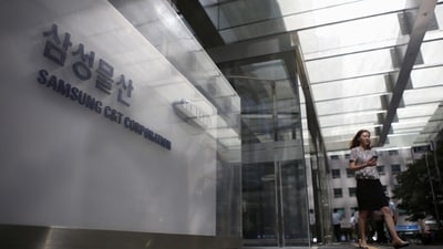 An employee walks past a logo of Samsung C&T Corp at the company's headquarters in Seoul, South Korea. (Reuters file)