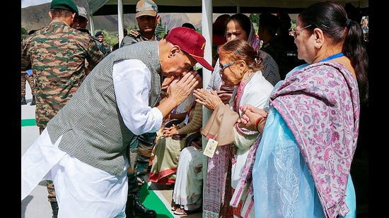 Defence minister Rajnath Singh interacts with the war Heroes, Veer Naris and the families of Bravehearts at Kargil War Memorial on the occasion of Kargil Vijay Diwas, in Drass, Ladakh on Wednesday. (PTI)