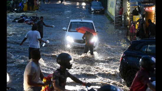 People wade through the waterlogged street amid heavy rainfall, at Malakpet, in Hyderabad on July 24, 2023. (ANI)