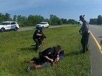FILE PHOTO: Truck driver Jadarrius Rose, 23 is handcuffed by an Ohio State Highway Patrol (OSHP) officer as a police dog is held back after Rose was attacked by the animal during a traffic stop south of Columbus, Ohio, U.S. July 4, 2023 in a still image from police body camera video.  Ohio State Highway Patrol/Handout via REUTERS  THIS IMAGE HAS BEEN SUPPLIED BY A THIRD PARTY.  THIS PICTURE WAS PROCESSED BY REUTERS TO ENHANCE QUALITY. AN UNPROCESSED VERSION HAS BEEN PROVIDED SEPARATELY./File Photo