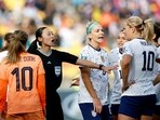 Referee Yoshimi Yamashita talks to Lindsey Horan of the U.S. and Netherlands' Danielle van de Donk 