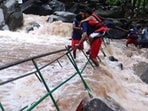 Tourists stuck in the Muthyala Dhara waterfalls in Mulugu district in Telangana as water flow increased.