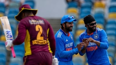 India's Ravindra Jadeja, right, celebrates with captain Rohit Sharma the dismissal of West Indies' Shimron Hetmyer (AP)