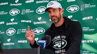 Quarterback Aaron Rodgers #8 of the New York Jets talks to reporters after training camp (Getty Images via AFP) Quarterback Aaron Rodgers #8 of the New York Jets talks to reporters after training camp (Getty Images via AFP)