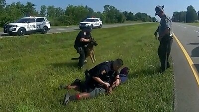 FILE PHOTO: Truck driver Jadarrius Rose, 23 is handcuffed by an Ohio State Highway Patrol (OSHP) officer as a police dog is held back after Rose was attacked by the animal during a traffic stop south of Columbus, Ohio, U.S. July 4, 2023 in a still image from police body camera video.  Ohio State Highway Patrol/Handout via REUTERS  THIS IMAGE HAS BEEN SUPPLIED BY A THIRD PARTY.  THIS PICTURE WAS PROCESSED BY REUTERS TO ENHANCE QUALITY. AN UNPROCESSED VERSION HAS BEEN PROVIDED SEPARATELY./File Photo (via REUTERS)