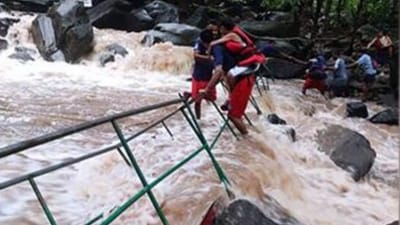 Tourists stuck in the Muthyala Dhara waterfalls in Mulugu district in Telangana as water flow increased. (Mint) Tourists stuck in the Muthyala Dhara waterfalls in Mulugu district in Telangana as water flow increased. (Mint)