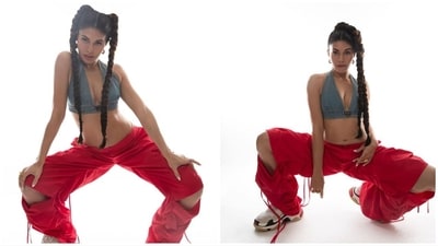 She paired it with a bright red pair of trousers with ripped knees, a loose fit and a set of straps attached to them. (Instagram/@jacquelienefernandez)