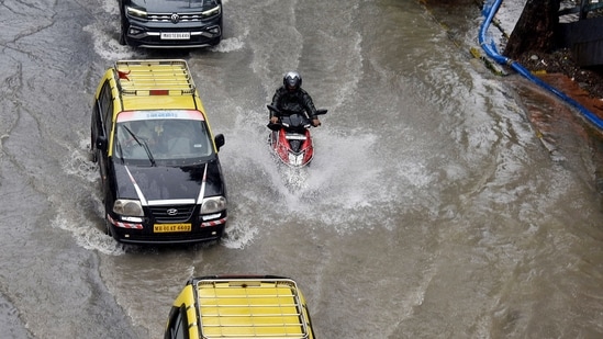 Vehicles wade through the waterlogged streets of Marine Lines and Churchgate East after heavy rainfall. (ANI Photo)