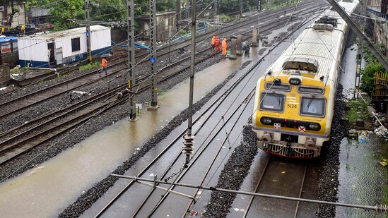 A train runs on a waterlogged railway track between Marine Lines and Churchgate after monsoon rainfall, in Mumbai.(PTI)