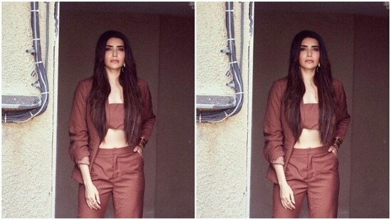 Karishma decked up in a maroon cropped top and layered it with a matching blazer and a pair of maroon formal trousers.&nbsp;(Instagram/@karishmaktanna)