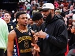 (FILES) Bronny James, #6 of the West team, talks to Lebron James, of the Los Angeles Lakers, after the 2023 McDonald's High School Boys All-American Game at Toyota Center in Houston, Texas, on March 28, 2023. Bronny James, the eldest son of NBA superstar LeBron James, is in a stable condition after suffering a cardiac arrest during a practice with his college basketball team, the James family said on July 25, 2023. (Photo by Alex Bierens de Haan / GETTY IMAGES NORTH AMERICA / AFP)