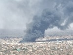 Drone footage shows birds in the foreground as clouds of black smoke billow over Bahri, Khartoum North, Sudan.