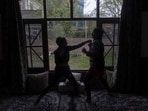 Wushu artist Aliza Shah (L), spars with her sister Kaifa Shah inside their home in Srinagar. Wushu artist Aliza Shah (L), spars with her sister Kaifa Shah inside their home in Srinagar.