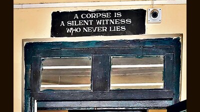 A board is seen outside the main door of Imphal’s Regional Institute of Medical Sciences, where coffins are stacked. (HT Photo) A board is seen outside the main door of Imphal’s Regional Institute of Medical Sciences, where coffins are stacked. (HT Photo)