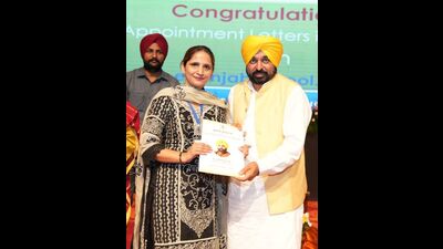 CM Bhagwant Mann handing over regularisation letter to a teacher in Chandigarh on Friday. (HT Photo) CM Bhagwant Mann handing over regularisation letter to a teacher in Chandigarh on Friday. (HT Photo)
