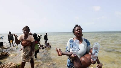 Migrants from Africa, stranded on the seashore at the Libyan-Tunisian border in Ras Jedir, react towards journalists on July 26. (AFP) Migrants from Africa, stranded on the seashore at the Libyan-Tunisian border in Ras Jedir, react towards journalists on July 26. (AFP)