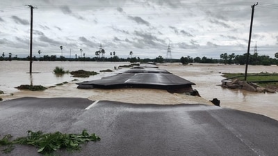 A partially damaged road is seen submerged in the floodwaters of the swollen Godavari River, in Bhupalpally. (PTI) A partially damaged road is seen submerged in the floodwaters of the swollen Godavari River, in Bhupalpally. (PTI)
