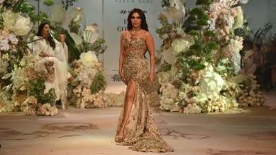 Bhumi Pednekar was all glammed up in a golden gown by designer Varun Bahl during the FDCI India Couture Week in New Delhi. She wore matching heels and pendants with the gown. (AFP) Bhumi Pednekar was all glammed up in a golden gown by designer Varun Bahl during the FDCI India Couture Week in New Delhi. She wore matching heels and pendants with the gown. (AFP)