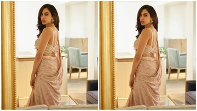 She paired her saree with a matching blouse with thin sleeves, plunging neckline and an ornate crystal detailing in the back. (Instagram/@sobhitad) She paired her saree with a matching blouse with thin sleeves, plunging neckline and an ornate crystal detailing in the back. (Instagram/@sobhitad)