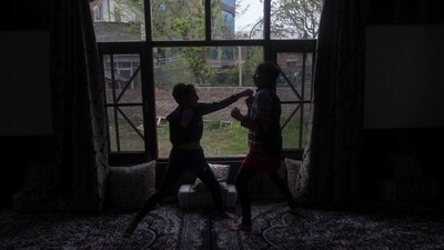 Wushu artist Aliza Shah (L), spars with her sister Kaifa Shah inside their home in Srinagar. (AP) Wushu artist Aliza Shah (L), spars with her sister Kaifa Shah inside their home in Srinagar. (AP)