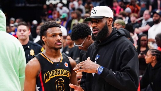 (FILES) Bronny James, #6 of the West team, talks to Lebron James, of the Los Angeles Lakers, after the 2023 McDonald's High School Boys All-American Game at Toyota Center in Houston, Texas, on March 28, 2023. Bronny James, the eldest son of NBA superstar LeBron James, is in a stable condition after suffering a cardiac arrest during a practice with his college basketball team, the James family said on July 25, 2023. (Photo by Alex Bierens de Haan / GETTY IMAGES NORTH AMERICA / AFP) (AFP)