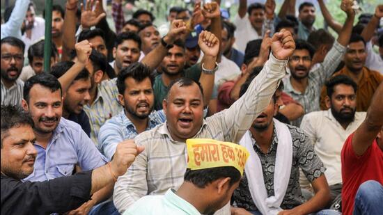 Haryana government clerks sitting on protest in Gurugram on Friday. (HT Photo)