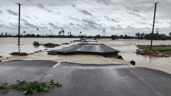 A partially damaged road is seen submerged in the floodwaters of the swollen Godavari River, in Bhupalpally. (PTI)