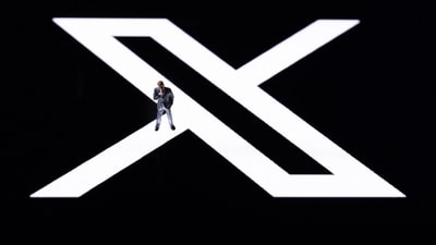 This illustration photo shows a figurine displayed on the new Twitter logo rebranded as X reflected in smartphone screen, in Paris on July 27. (AFP) This illustration photo shows a figurine displayed on the new Twitter logo rebranded as X reflected in smartphone screen, in Paris on July 27. (AFP)