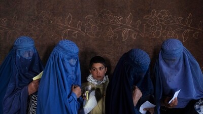 Afghan women wait to receive cash at a money distribution point organized by the World Food Program, in Kabul, Afghanistan (AP) Afghan women wait to receive cash at a money distribution point organized by the World Food Program, in Kabul, Afghanistan (AP)