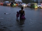 A woman wades through the waterlogged Delhi-Gurugram Expressway amid heavy rains, in Gurugram on Friday. (ANI Photo)
A woman wades through the waterlogged Delhi-Gurugram Expressway amid heavy rains, in Gurugram on Friday. (ANI Photo)