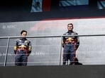 Winner Red Bull Racing's Dutch driver Max Verstappen (C), second-placed Red Bull Racing's Mexican driver Sergio Perez (L) and third-placed Ferrari's Monegasque driver Charles Leclerc (R) pose on the podium Winner Red Bull Racing's Dutch driver Max Verstappen (C), second-placed Red Bull Racing's Mexican driver Sergio Perez (L) and third-placed Ferrari's Monegasque driver Charles Leclerc (R) pose on the podium
